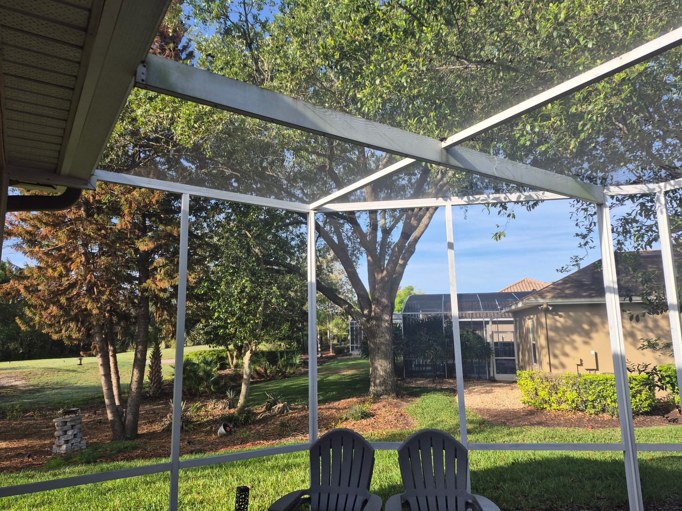 Open screened backyard for supervised cage-free dog sitting and dog day care in DeBary FL